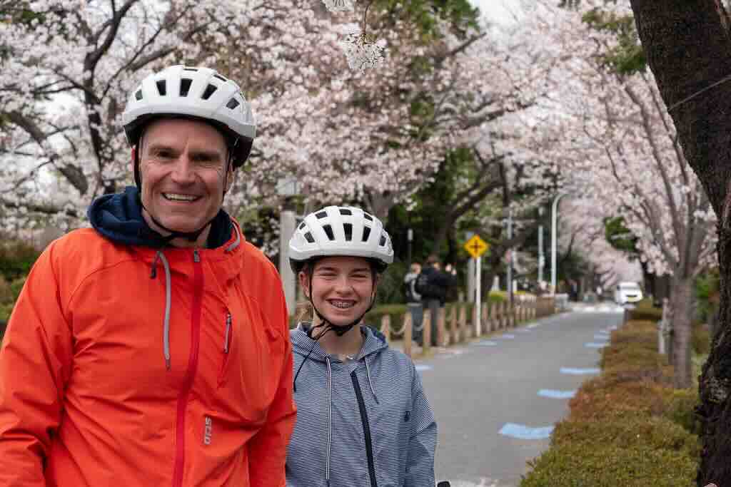 Smiles under pink blossoms.